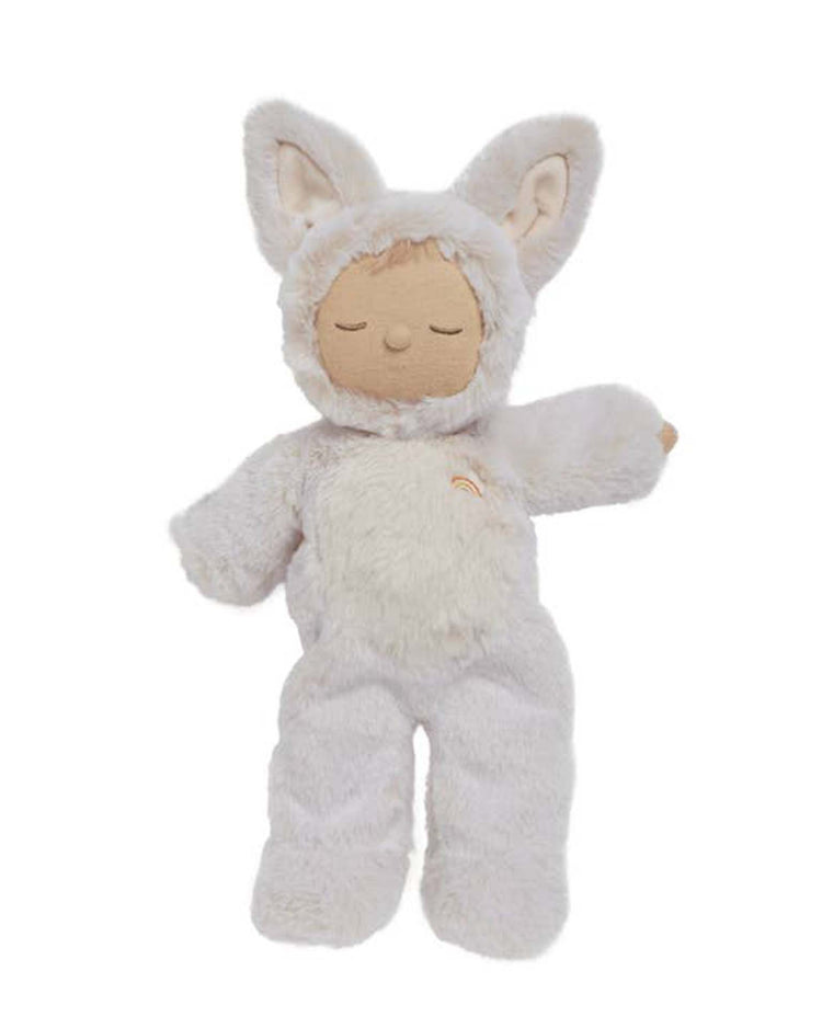 The cozy dinkum fox fenix by Olli Ella is a doll in a fluffy white animal outfit with closed eyes, large bunny-like ears, and beige accents.