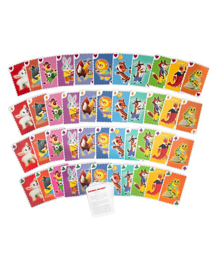 A circular arrangement of colorful cards from eeboo's Animal Rummy Playing Cards features various cartoon animals in a vintage design. At the center is a white instruction sheet with text, making it perfect for an engaging children's card game like Animal Rummy.