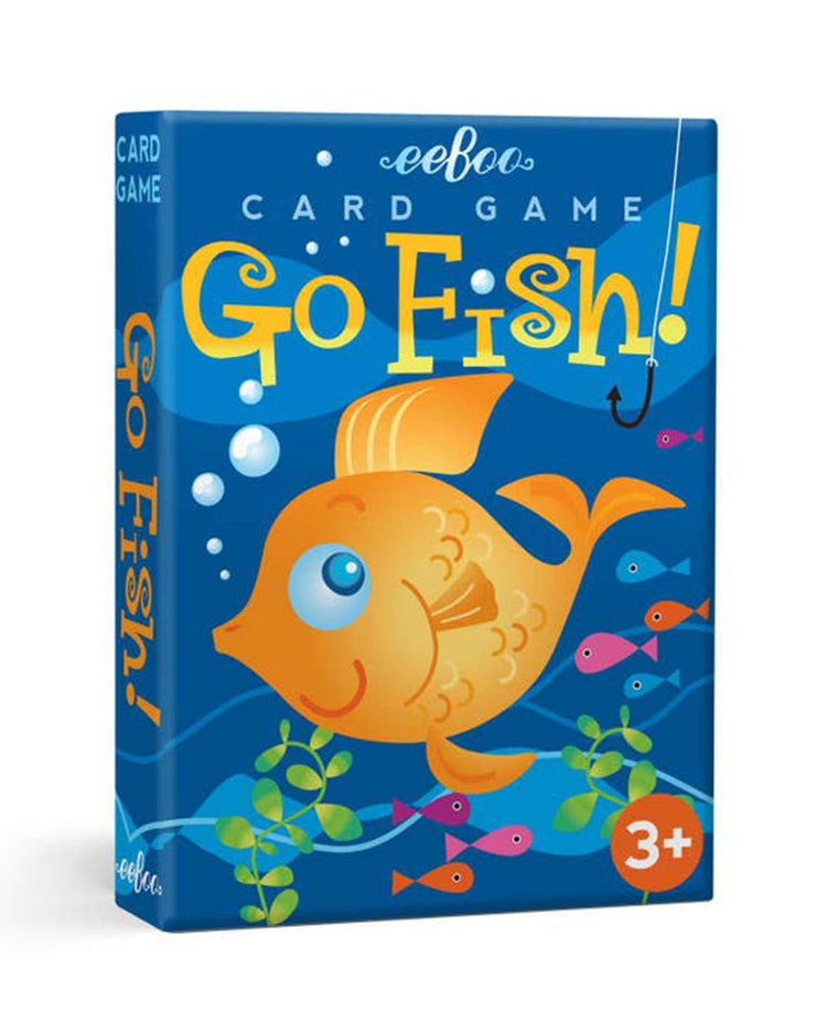 Image of a blue box for a card game titled "eeboo Color Go Fish Playing Cards." It features an illustration of an orange fish and smaller colorful fish-shaped cards, labeled for ages 3 and up. Perfect as a first card game, it encourages color matching for young players.