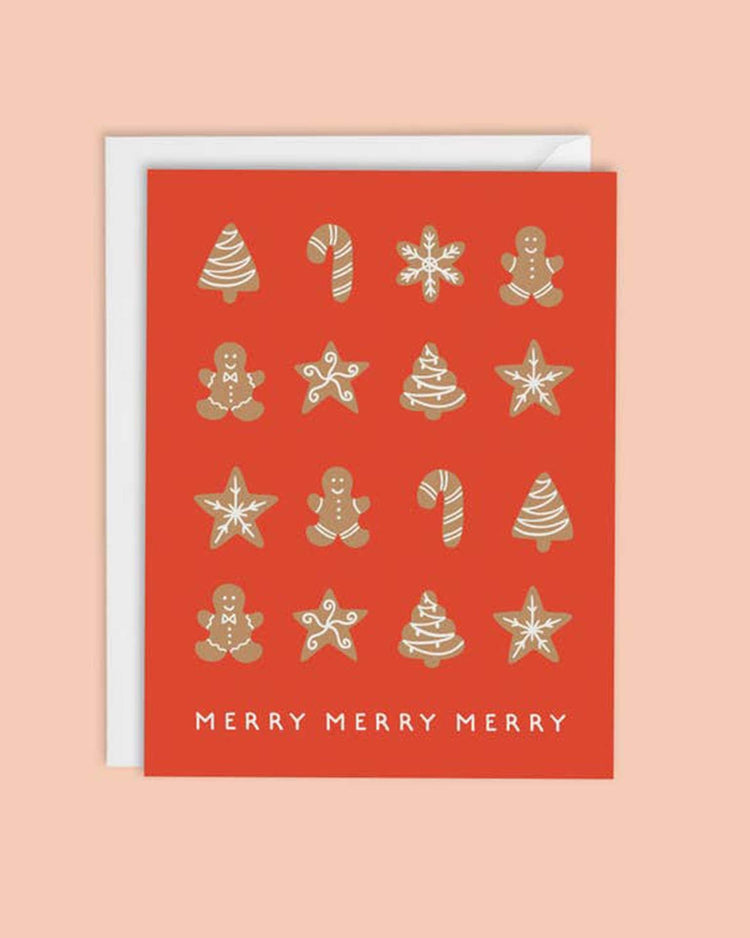 The gingerbread cookies card by mellowworks is a red Christmas card adorned with the white text "Merry Merry Merry." It showcases gold and white illustrations of gingerbread men, candy canes, stars, and Christmas trees. The interior is blank for your personal message.