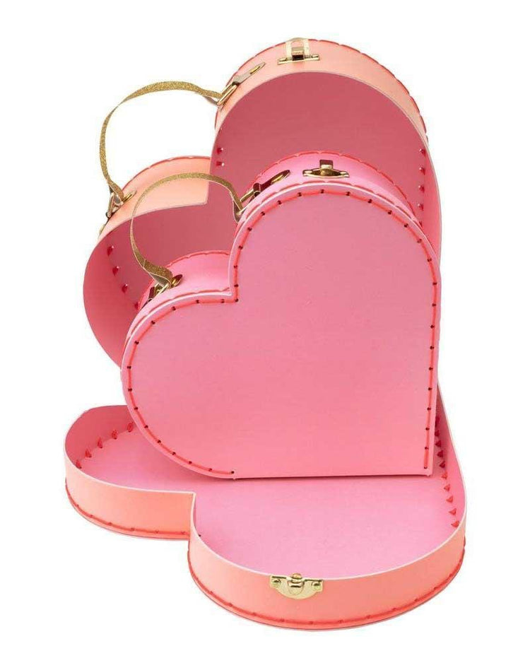 Three heart-shaped pink meri meri gift boxes stacked open on top of each other, perfect for Valentine's Day.